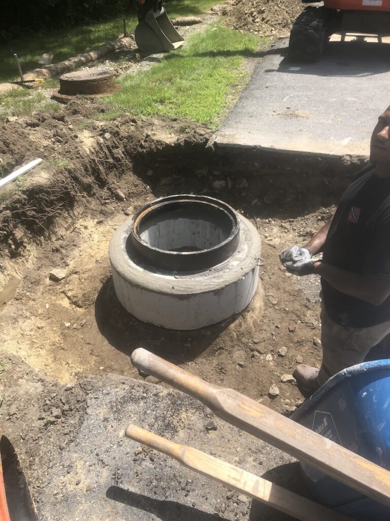 photo of a manhole repaired in Weston MA by EmRay Excavating